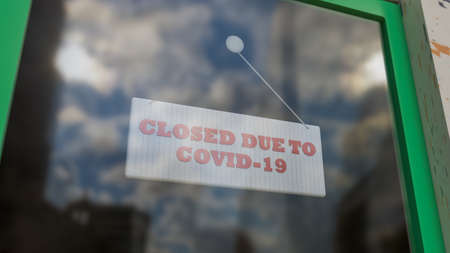 Closed Sign on Shop Window. Store sign. Close-up on a closed sign in the window of a shop displaying the message. The glass reflects the day city and the sky. 3d renderingの写真素材
