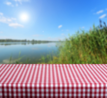 Empty wooden table and beautiful summer lake  in background. Great for product display montagesの写真素材