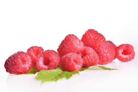 Very tasty summer raspberries with green leafの写真素材