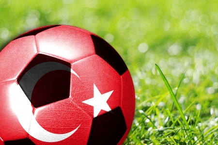 Soccer ball on grass with flag of Turkey painted on itの写真素材
