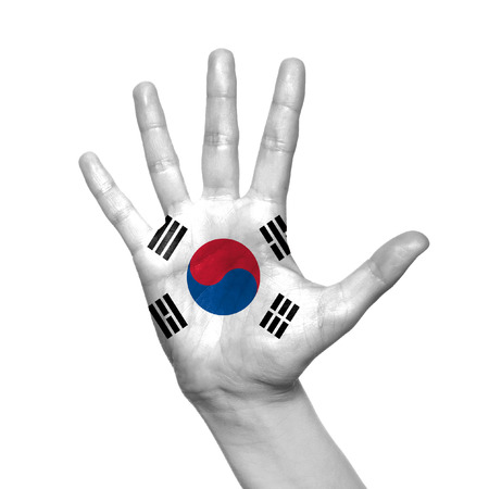 Korea flag painted on hand over white backgroundの写真素材