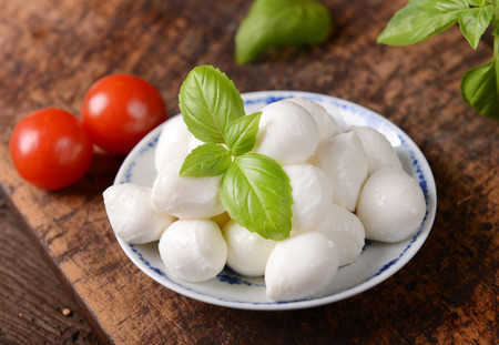 Tasty mozzarella cheese on old wooden tableの写真素材