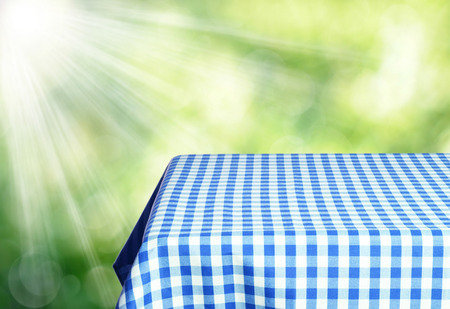 Empty table and defocused fresh green backgroundの写真素材