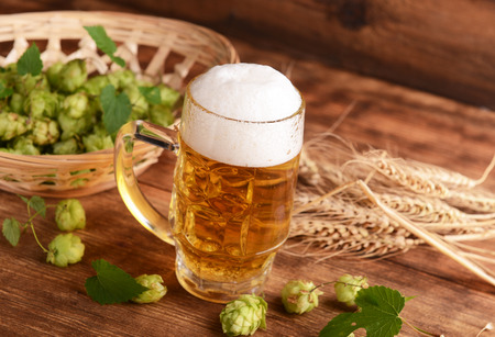 Beer and hops on wooden backgroundの写真素材