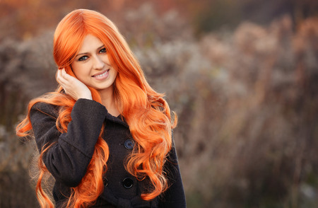 Beautiful autumn portrait of red haired caucasian girlの写真素材