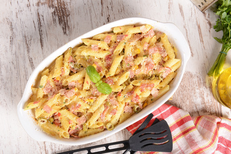 Penne pasta casserole with cheese, ham and cornの写真素材