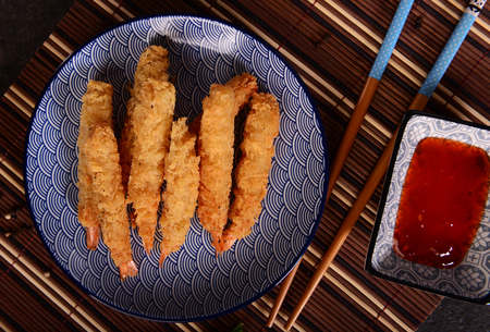 Fried shrimps on sticks in crispy coatingの写真素材
