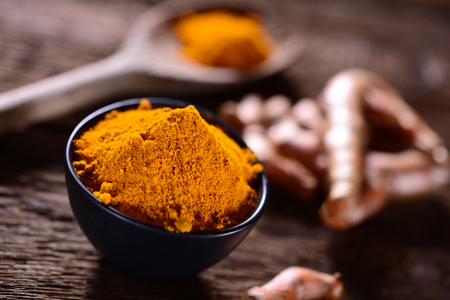 Turmeric spice on old wooden table