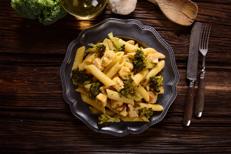 Penne pasta with broccoli and chicken with cheese sauceの写真素材