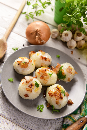 Meat stuffed potato dumplings with fried onion  and greaves on topの写真素材