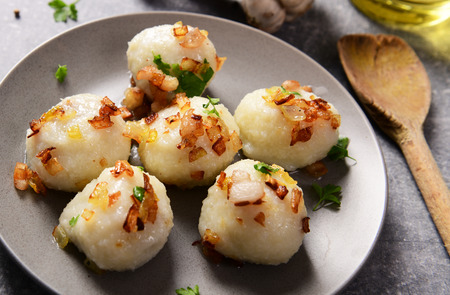 Meat stuffed potato dumplings with fried onion  and greaves on topの写真素材