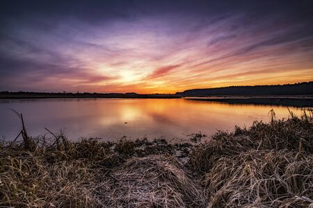 Beautiful sunrise over lake banksの写真素材