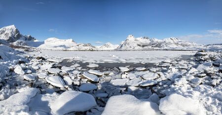 Winter landscape with mountains and frozen lake - panoramaの写真素材