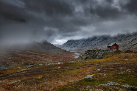 Dark landscape of Norway mountains covered with heavy cloudsの写真素材