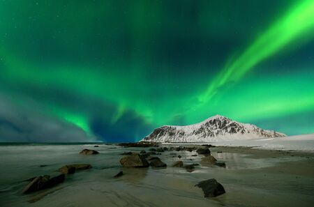 Aurora borealis also called northern lights over skagsanden beach in Norwayの写真素材