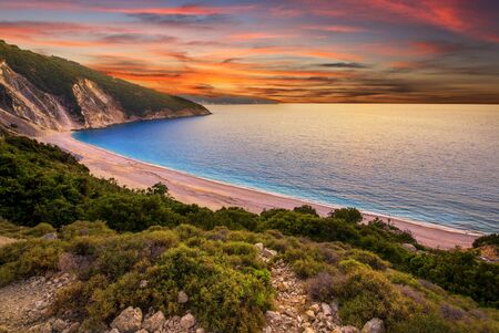 Beautiful summer sunset on Mirtos beach in Greeceの写真素材