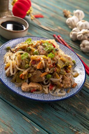 Chinese noodles with vegetables and chickenの写真素材