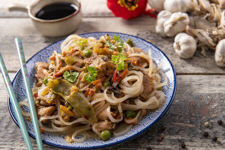 Chinese noodles with vegetables and chickenの写真素材
