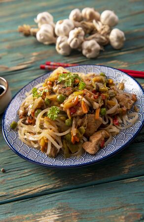 Chinese noodles with vegetables and chickenの写真素材
