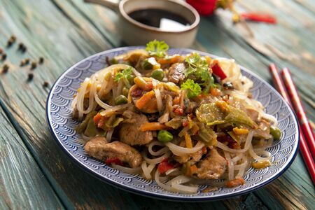 Chinese noodles with vegetables and chickenの写真素材