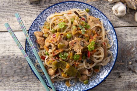 Chinese noodles with vegetables and chickenの写真素材