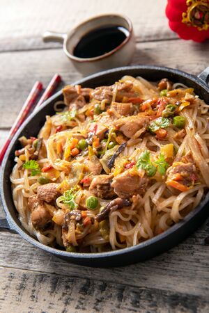 Chinese noodles with vegetables and chickenの写真素材