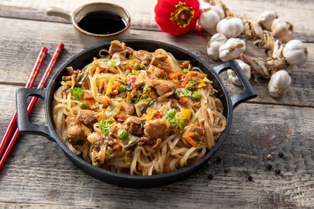 Chinese noodles with vegetables and chickenの写真素材