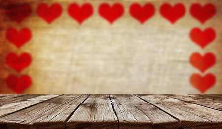 Empty old wooden table background with valentines day theme in backgroundの写真素材