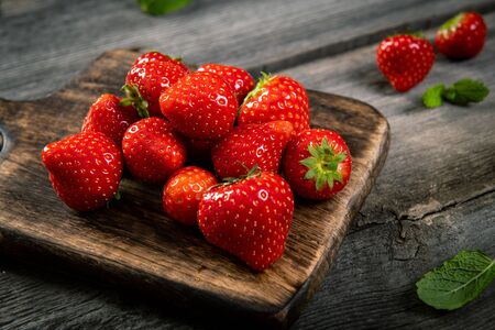 Fresh picked tasty strawberries on wooden backgroundの写真素材
