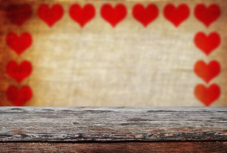 Empty old wooden table background with valentines day theme in backgroundの写真素材