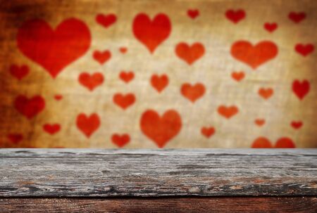 Empty old wooden table background with valentines day theme in backgroundの写真素材