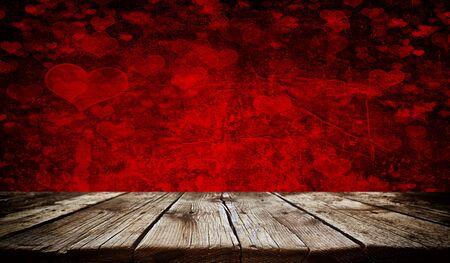 Empty old wooden table background with valentines day theme in backgroundの写真素材