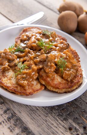 Tasty homemade potato pancakes with meat and mushroomsの写真素材