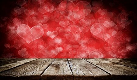 Empty old wooden table background with valentines day theme in backgroundの写真素材