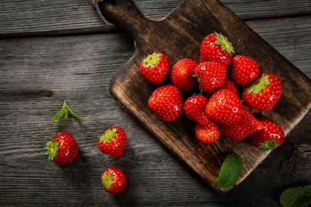 Fresh picked tasty strawberries on wooden backgroundの写真素材