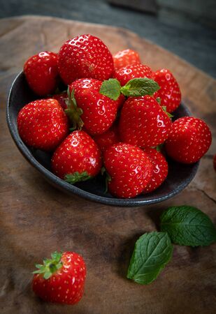Fresh picked tasty strawberries on wooden backgroundの写真素材