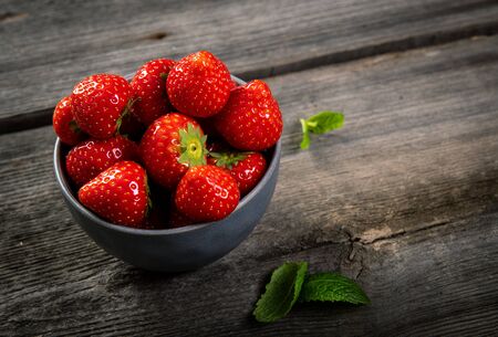 Fresh picked tasty strawberries on wooden backgroundの写真素材