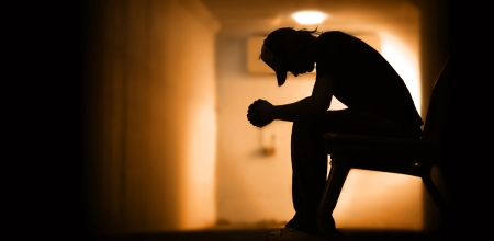 Young man with hands clasped together Young man with hands clasped together