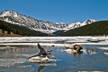 Fozen lake with Mountains in the Backgroundの写真素材
