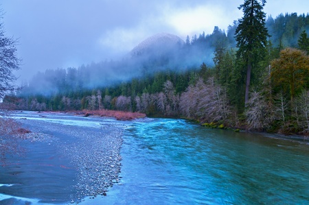 Quinault River and mountanis against cold dramatic sky