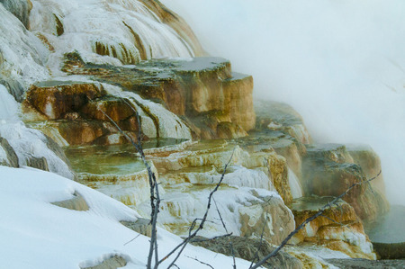 Hot steaming water beautiful cascade geyser - winter landscape in Yellowstone National Parkの写真素材
