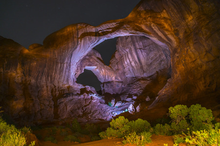Long Exposure light painting with stars Double arch moab utah Arches National Parkの写真素材
