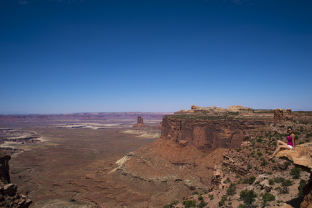 Attractive women sitting at the edge of the canyon rimの写真素材
