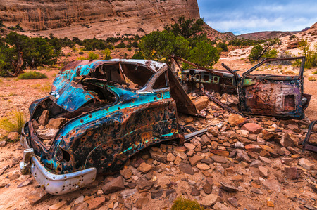 Abandoned Car wreck with bullet holes, Utah canyonの写真素材