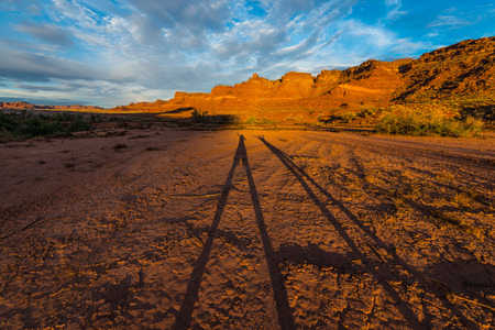 Shadow of two happy hikers White Canyon Lake Powell at Sunsetの写真素材