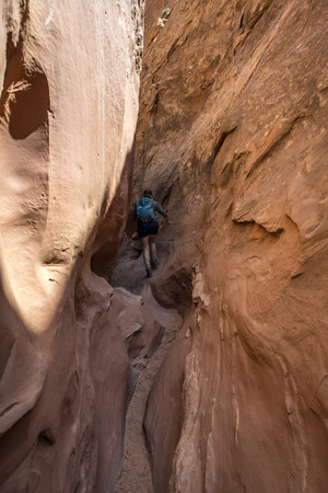 Woman Hiker Backpacker hiking narrow slot canyonの写真素材
