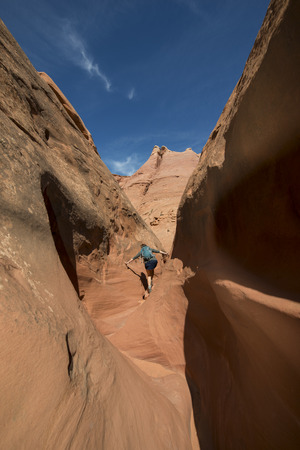 Woman Hiker Backpacker hiking narrow slot canyonの写真素材