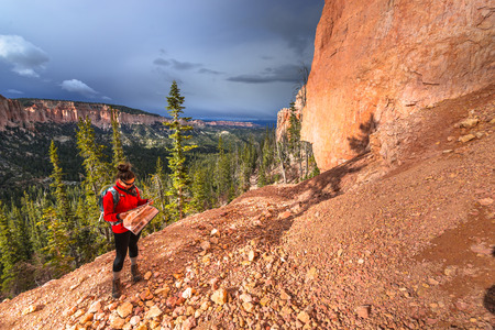 Woman Backpacker hiking down the Ponderosa Canyon Bryce National Parkの写真素材