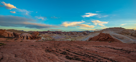 Fire Wave Panorama black pebbles, multicolored rock formations and blue sunset skyの写真素材