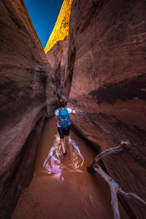 Backpacker Girl Entering Zebra Slot Canyon Escalante Utahの写真素材